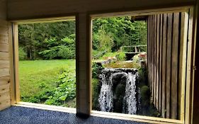 Wooden House With A Waterfall 